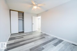 Unfurnished bedroom with a ceiling fan, light wood-style floors, and a closet - 