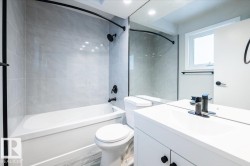 Bathroom with vanity, bathtub / shower combination, wood finished floors, and recessed lighting - 