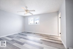 Unfurnished room featuring a textured ceiling, light wood-style flooring, and a ceiling fan - 