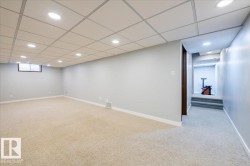 Below grade area featuring light carpet, a drop ceiling, and recessed lighting - 