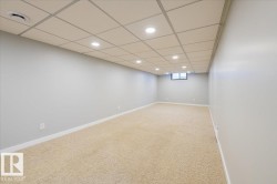 Basement featuring recessed lighting, carpet flooring, and a drop ceiling - 