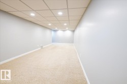 Finished basement with recessed lighting, light carpet, and a drop ceiling - 