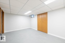 Basement with a drop ceiling and baseboards - 