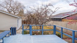 Wooden terrace with a fenced backyard - 