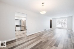 Unfurnished living room with baseboards and light wood finished floors - 