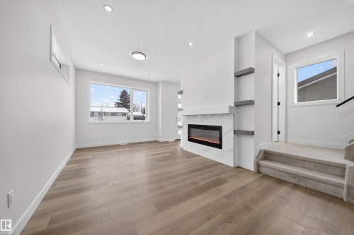 5213 104A Street, Edmonton, AB - Indoor Photo Showing Living Room With Fireplace