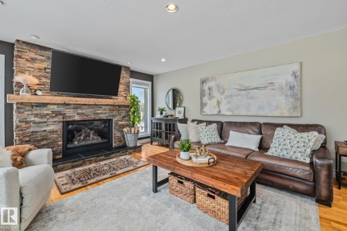2 Discovery Avenue, Rural Sturgeon County, AB - Indoor Photo Showing Living Room With Fireplace