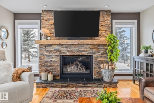 2 Discovery Avenue, Rural Sturgeon County, AB - Indoor Photo Showing Living Room With Fireplace
