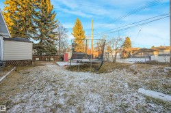Fenced backyard with a trampoline and a storage unit - 
