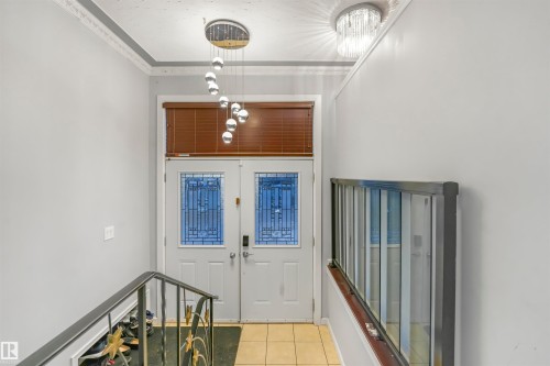Entryway featuring light tile patterned flooring and crown molding - 13335 106 Street, Edmonton, AB - Indoor Photo Showing Other Room