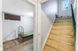 Stairway with wood finished floors and a textured ceiling - 