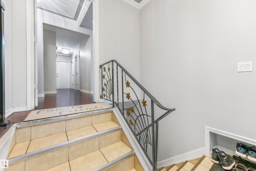 Stairway featuring baseboards and tile patterned flooring - 13335 106 Street, Edmonton, AB - Indoor Photo Showing Other Room