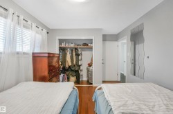 Bedroom featuring dark wood-style flooring and a closet - 