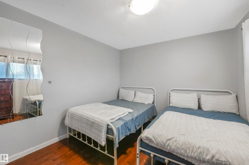 Bedroom featuring dark wood finished floors and baseboards - 13335 106 Street, Edmonton, AB - Indoor Photo Showing Bedroom