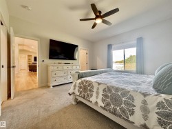 Bedroom with light carpet and ceiling fan - 