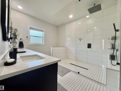 Full bathroom with double vanity, walk in shower, and recessed lighting - 
