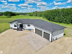 View of front of home with a shingled roof, driveway, and an attached garage - 