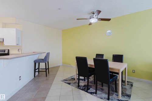 Dining space with light tile patterned flooring and a ceiling fan - 406 9120 156 Street, Edmonton, AB - Indoor