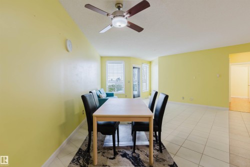 Dining room featuring light tile patterned floors and a ceiling fan - 406 9120 156 Street, Edmonton, AB - Indoor Photo Showing Dining Room