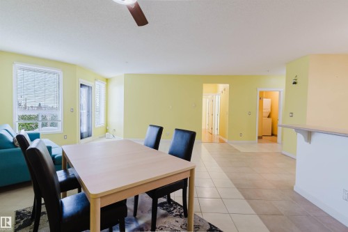Dining space with light tile patterned floors and ceiling fan - 406 9120 156 Street, Edmonton, AB - Indoor Photo Showing Dining Room