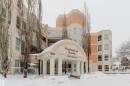 Snow covered building featuring a view of apartment building / complex - 406 9120 156 Street, Edmonton, AB  - Outdoor With Facade 