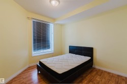 Bedroom featuring wood finished floors and a textured ceiling - 