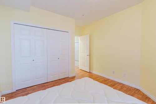 Bedroom featuring light wood finished floors and a closet - 406 9120 156 Street, Edmonton, AB - Indoor Photo Showing Bedroom
