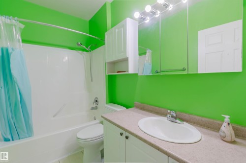 Full bathroom featuring shower / bath combination with curtain and vanity - 406 9120 156 Street, Edmonton, AB - Indoor Photo Showing Bathroom