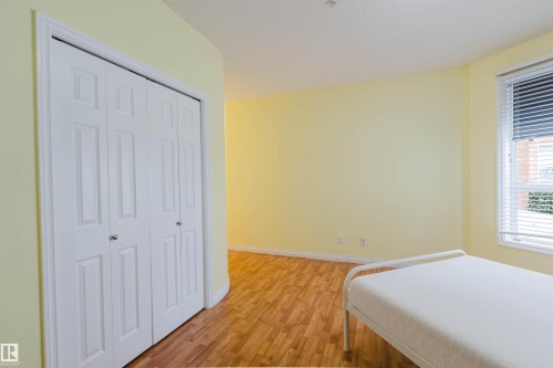 Bedroom featuring light wood finished floors and a closet - 406 9120 156 Street, Edmonton, AB - Indoor Photo Showing Bedroom