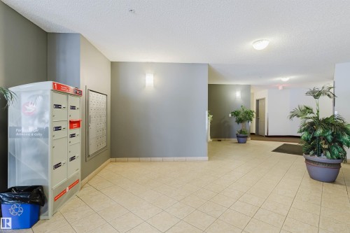 Common area with a textured ceiling - 406 9120 156 Street, Edmonton, AB - Indoor Photo Showing Other Room