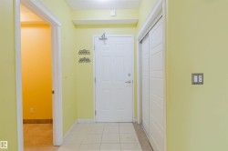 Doorway with tile patterned flooring and a textured ceiling - 