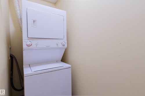 Laundry area featuring stacked washer / dryer - 406 9120 156 Street, Edmonton, AB - Indoor Photo Showing Laundry Room