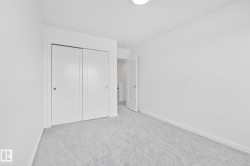 Unfurnished bedroom featuring light colored carpet and a closet - 