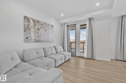Living area featuring wood finished floors and recessed lighting - 