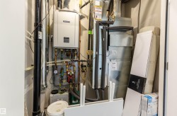Utility room featuring tankless water heater - 