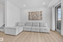 Living room featuring wood finished floors, recessed lighting, and stairs - 