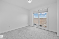 Carpeted empty room featuring baseboards - 