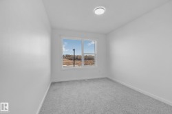 Empty room featuring baseboards and light colored carpet - 