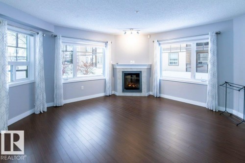 107 2045 Grantham Court, Edmonton, AB - Indoor Photo Showing Living Room With Fireplace
