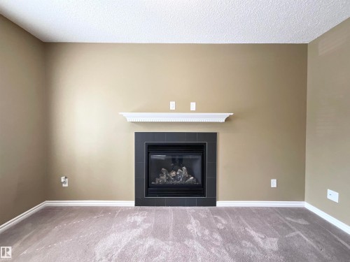 33 9350 211 Street, Edmonton, AB - Indoor Photo Showing Living Room With Fireplace