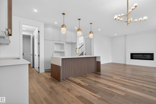 281 Paterson Link Link, Edmonton, AB - Indoor Photo Showing Kitchen With Fireplace