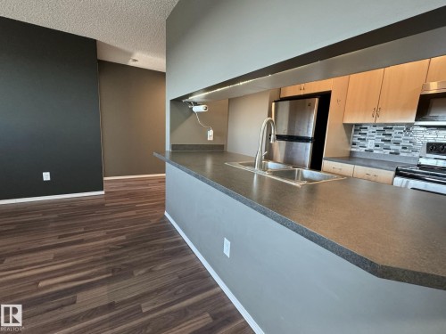 516 2430 Guardian Road, Edmonton, AB - Indoor Photo Showing Kitchen With Double Sink