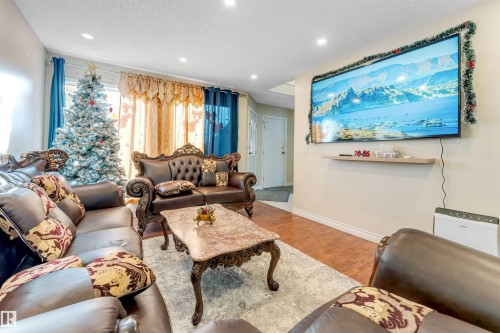 Living area featuring a textured ceiling, wood finished floors, and recessed lighting - 18404 97A Avenue, Edmonton, AB - Indoor Photo Showing Living Room
