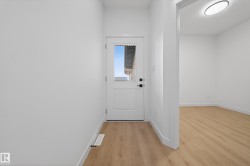 Doorway with wood finished floors and baseboards - 