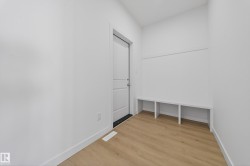 Mudroom with light wood-style flooring and baseboards - 