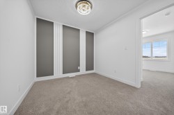 Unfurnished room with light colored carpet and a textured ceiling - 