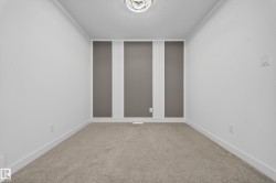 Spare room with a textured ceiling and light carpet - 