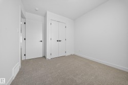 Unfurnished bedroom featuring light colored carpet and a closet - 