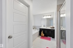 Bathroom with a stall shower, a textured ceiling, vanity, a garden tub, and light tile patterned floors - 