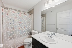Bathroom featuring vanity, a textured ceiling, and shower / bathtub combination with curtain - 